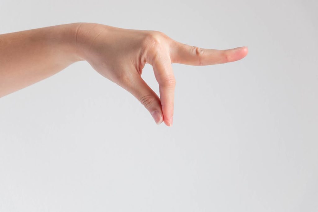 A woman’s hand paused in the salt sprinkling position