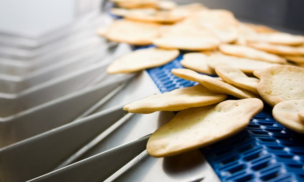 Crackers moving through a production line in a factory.